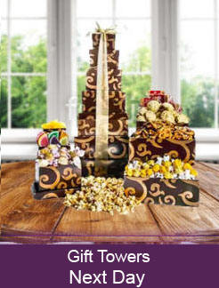 Gift towers filled with chocolate, snacks and treats in stackable keepsake boxes
